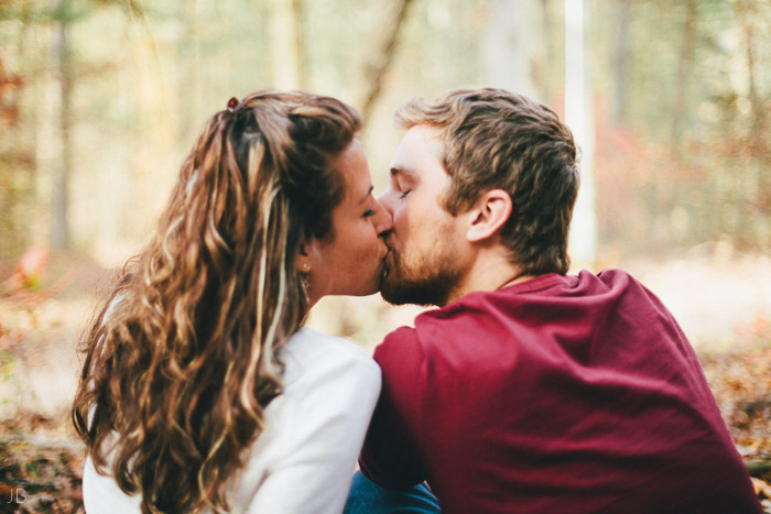 engagement session in the woods, surrounding a fire with smores and flannel in autumn