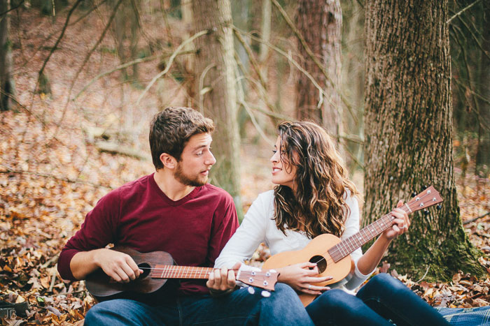 engagement session in the woods, surrounding a fire with smores and flannel in autumn