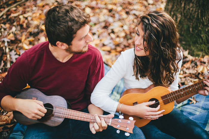 engagement session in the woods, surrounding a fire with smores and flannel in autumn