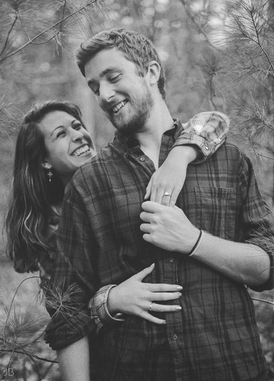 engagement session in the woods, surrounding a fire with smores and flannel in autumn