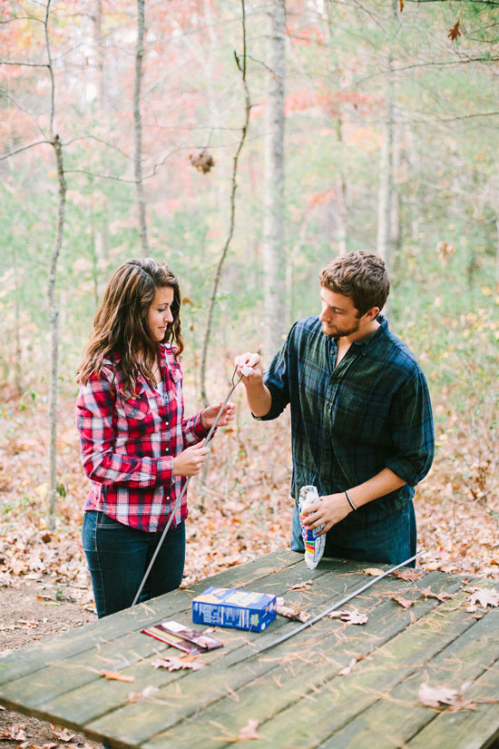 engagement session in the woods, surrounding a fire with smores and flannel in autumn