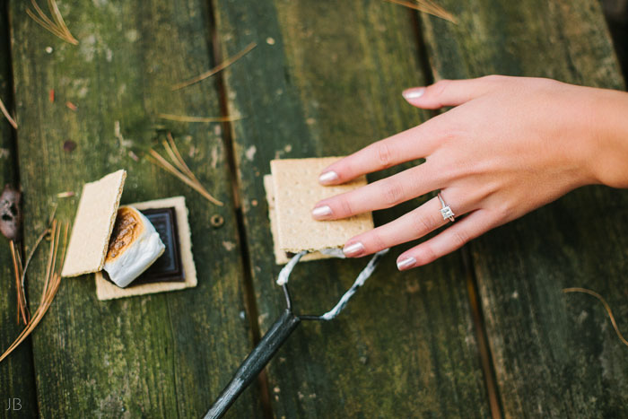 engagement session in the woods, surrounding a fire with smores and flannel in autumn