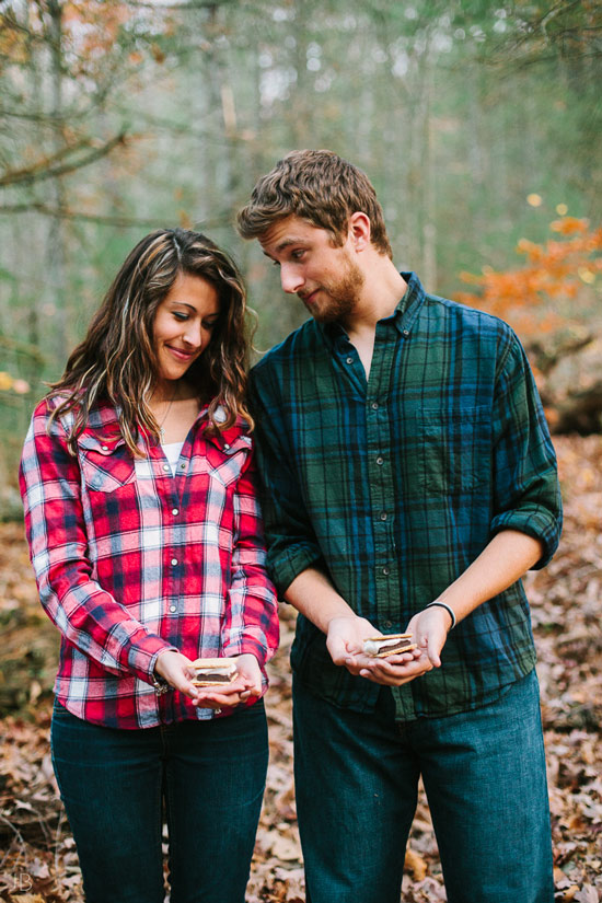 engagement session in the woods, surrounding a fire with smores and flannel in autumn