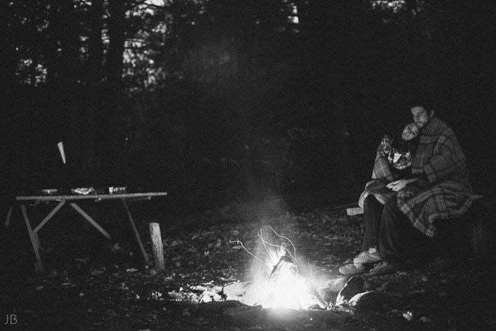 engagement session in the woods, surrounding a fire with smores and flannel in autumn