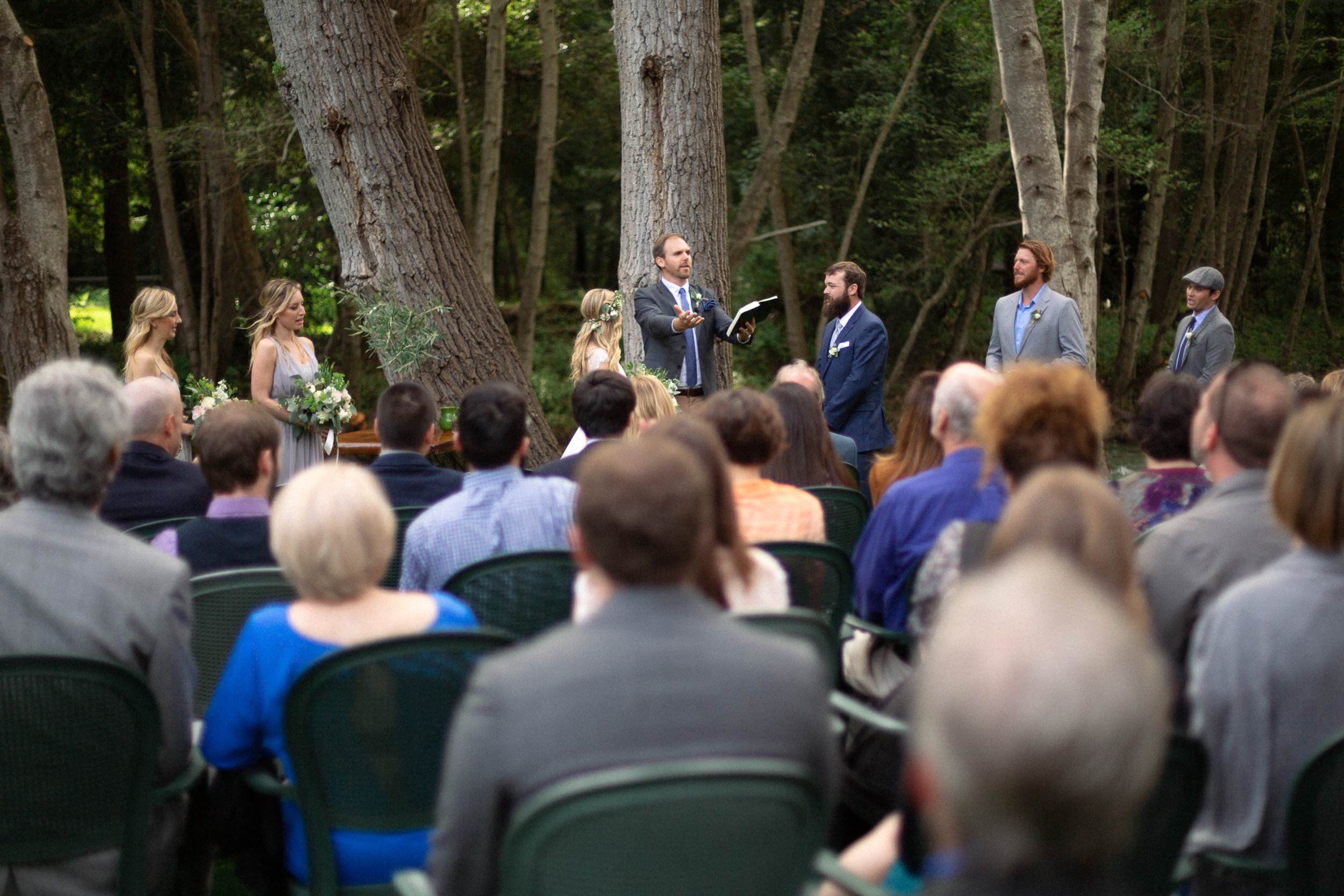 ceremony taking place at big sur river inn next to big sur river backdrop  - big sur california wedding - laid back wedding in big sur california - fuji provia film look true to life colors