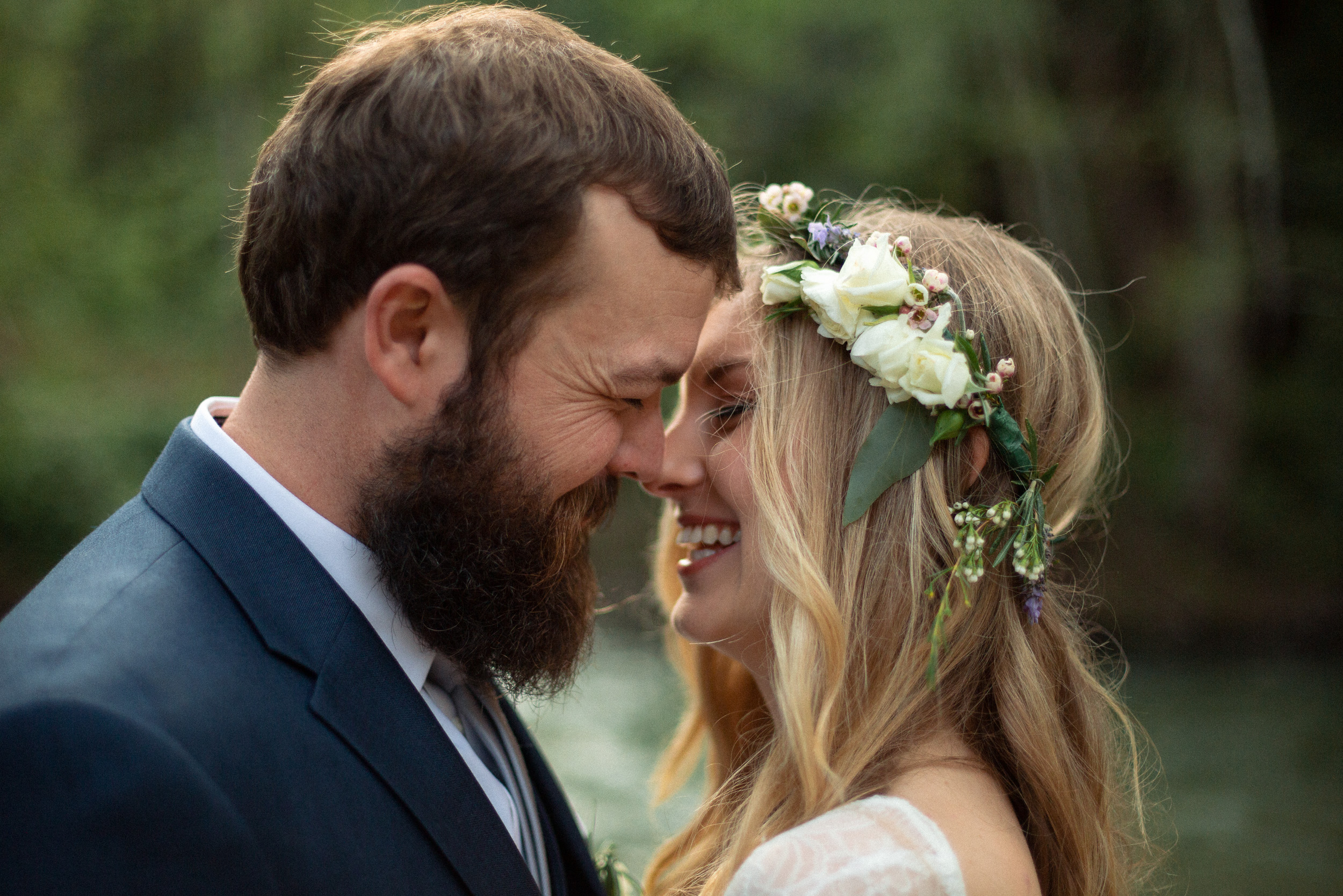 bride and groom posed kiss next to the big sur river - big sur california wedding - laid back wedding in big sur california