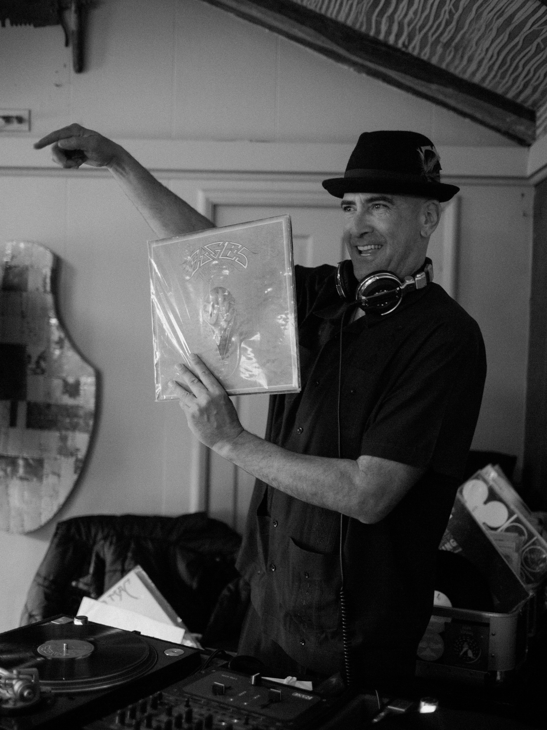 wedding dj shows vinyl about to be played at wedding reception - fuji acros black and white film look - documentary wedding photgraphy