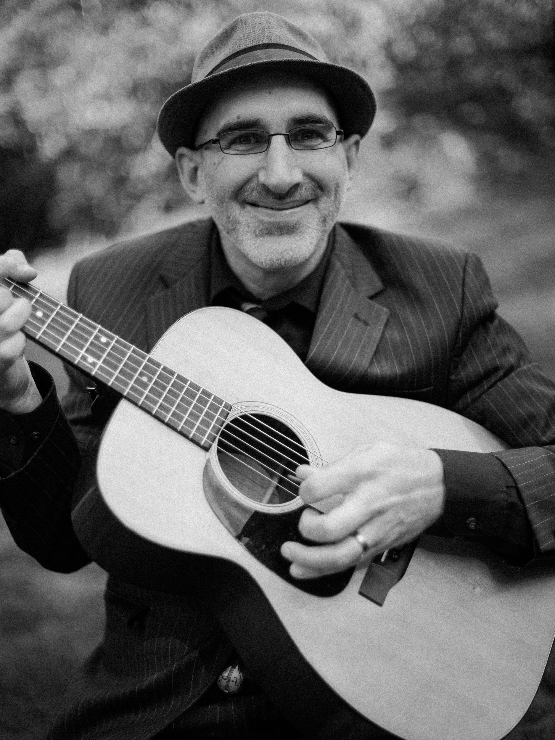 guitarist poses for camera at big sur river inn wedding - fuji acros film simulation for documentary look