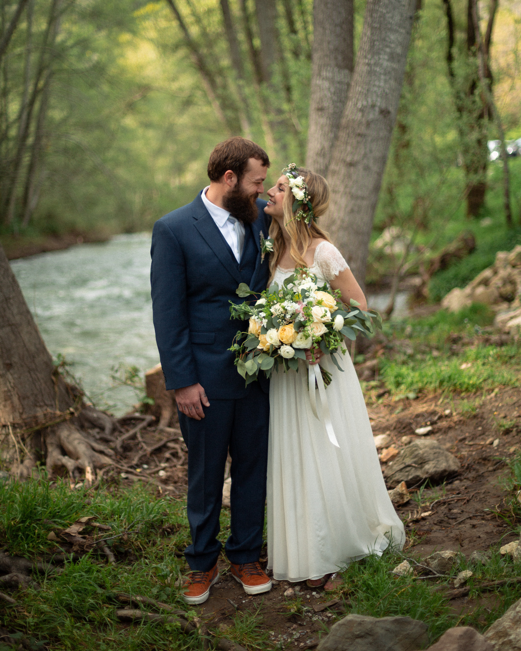 bride and groom posed kiss next to the big sur river - big sur california wedding - laid back wedding in big sur california - true to life colors