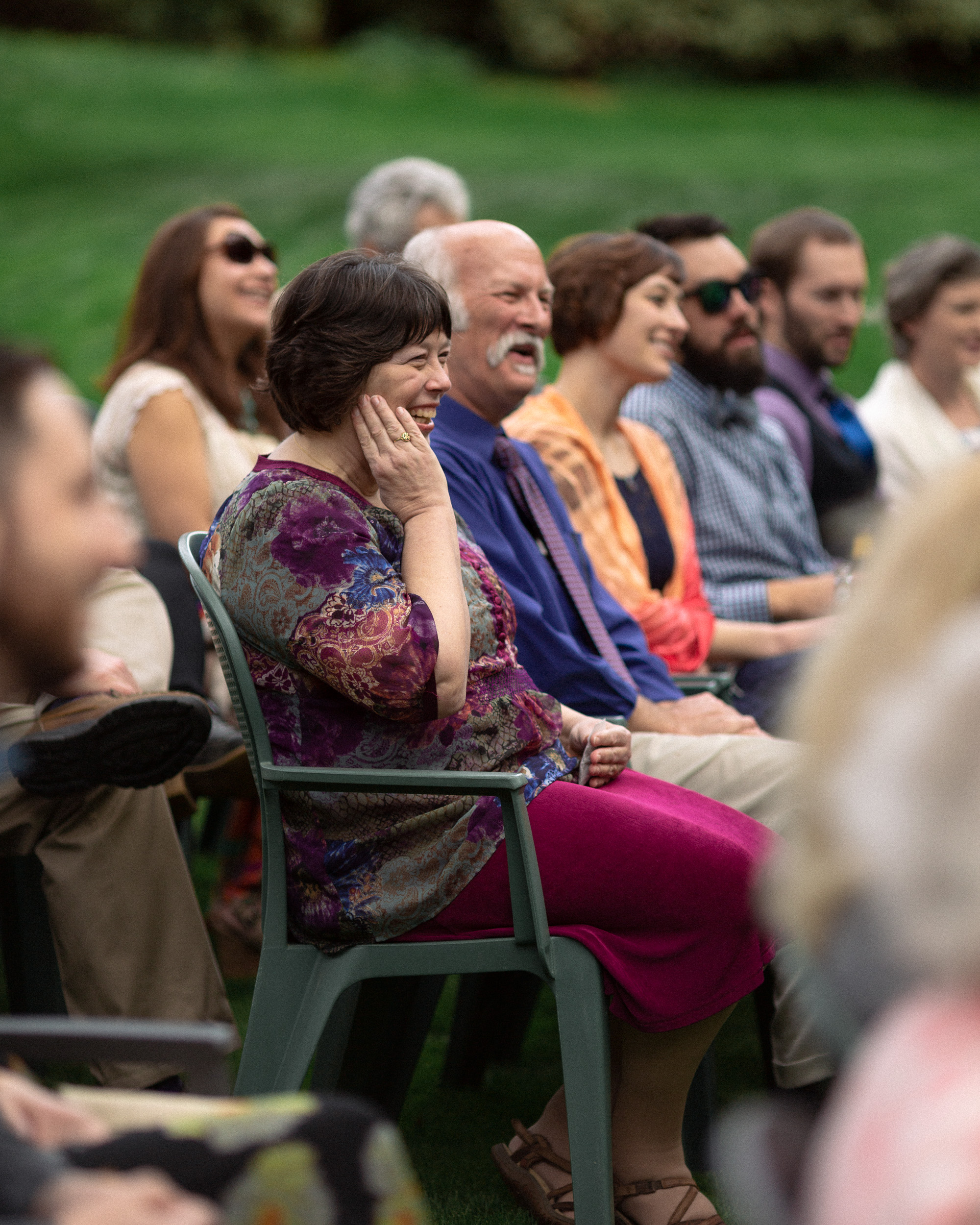 family members laugh during wedding ceremony  - big sur california wedding - laid back wedding in big sur california - fuji provia film look true to life colors