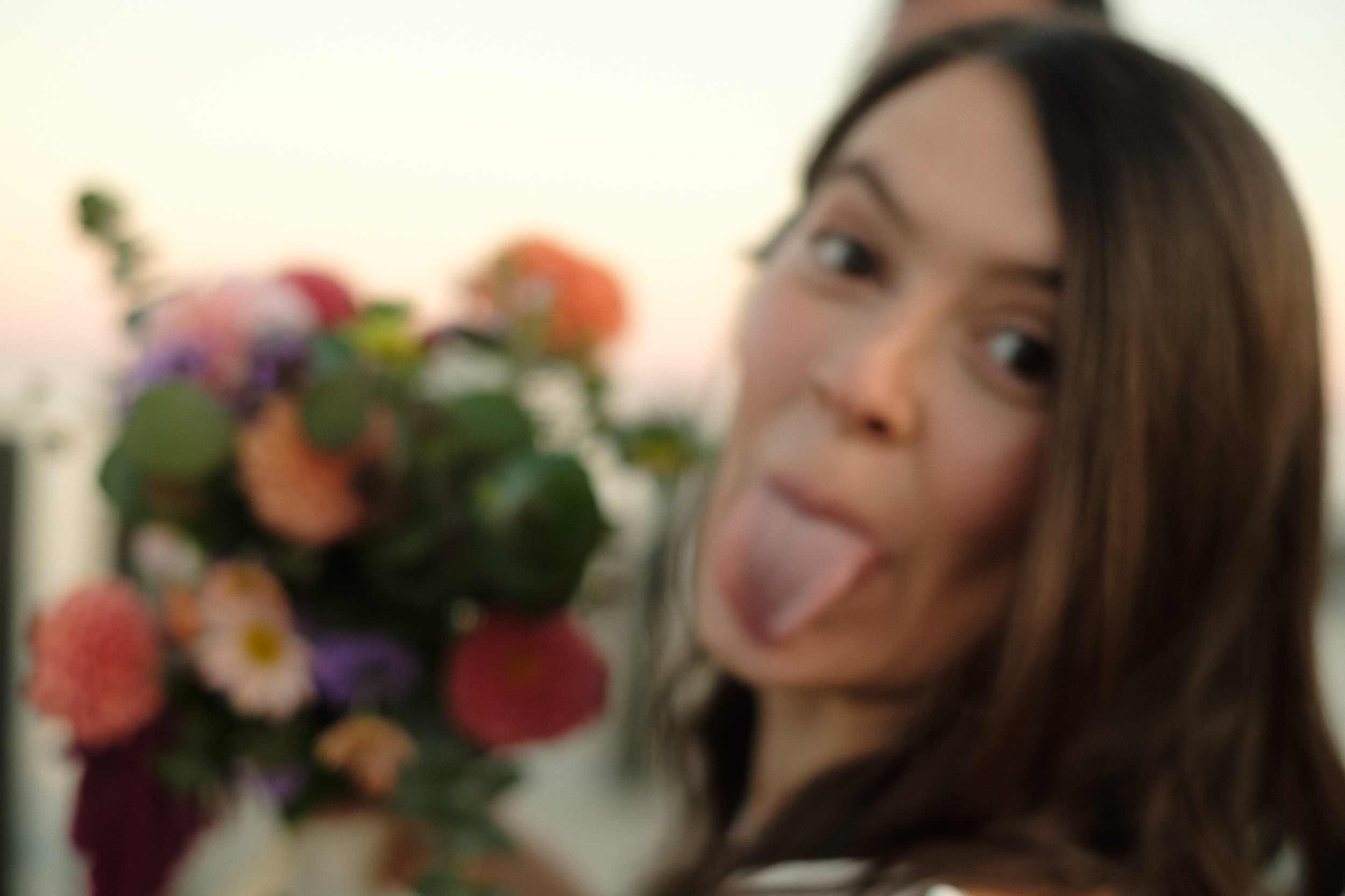 blurry wedding photo of bride sticking out tongue - documentary candid unstaged wedding photography - Annapolis Maryland wedding at Chesapeake Bay Foundation