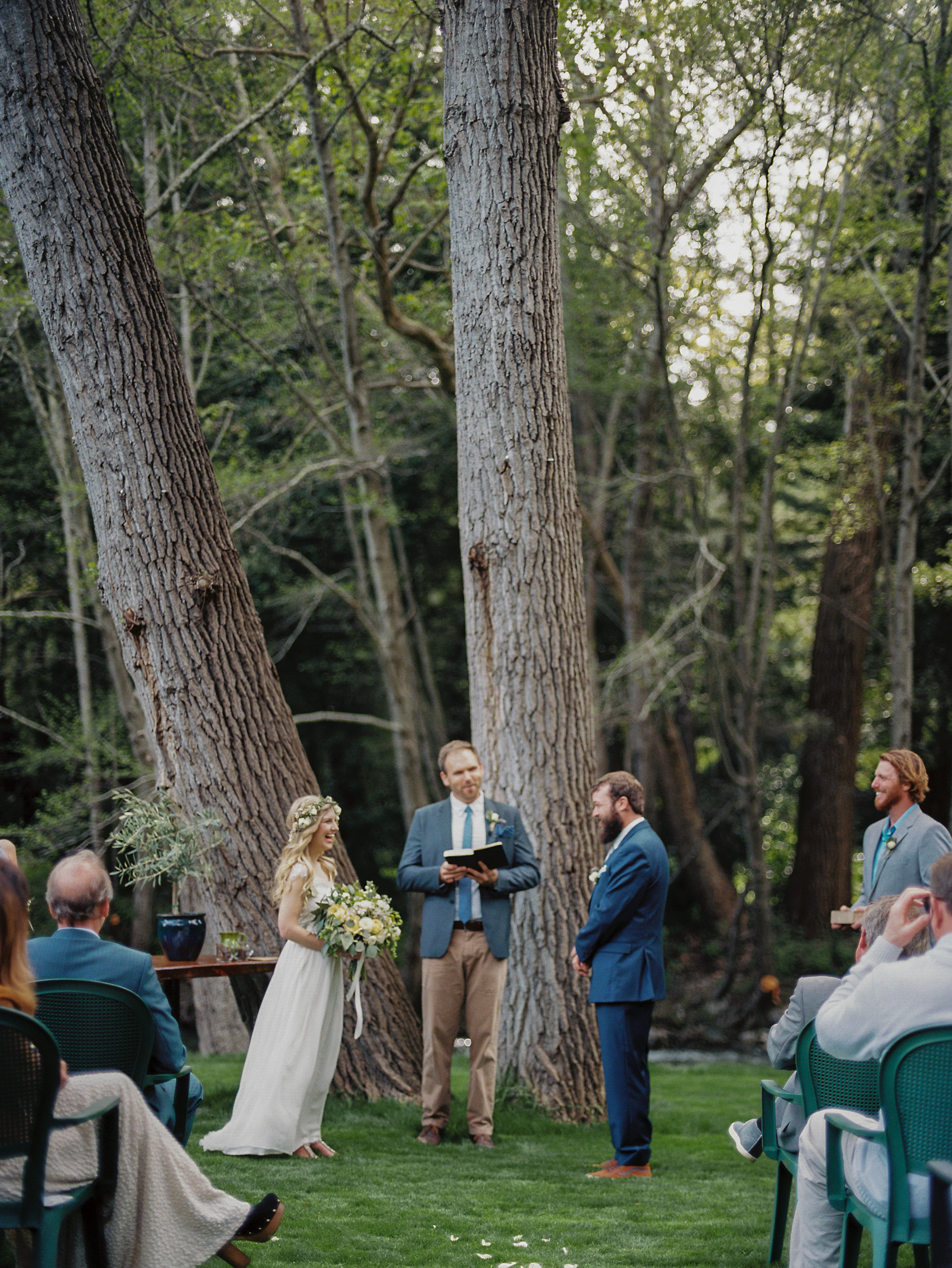 bride and groom standing next to cottonwood trees during their wedding ceremony in big sur california  - big sur california wedding - laid back wedding in big sur california - shot on fuji 400h medium format film