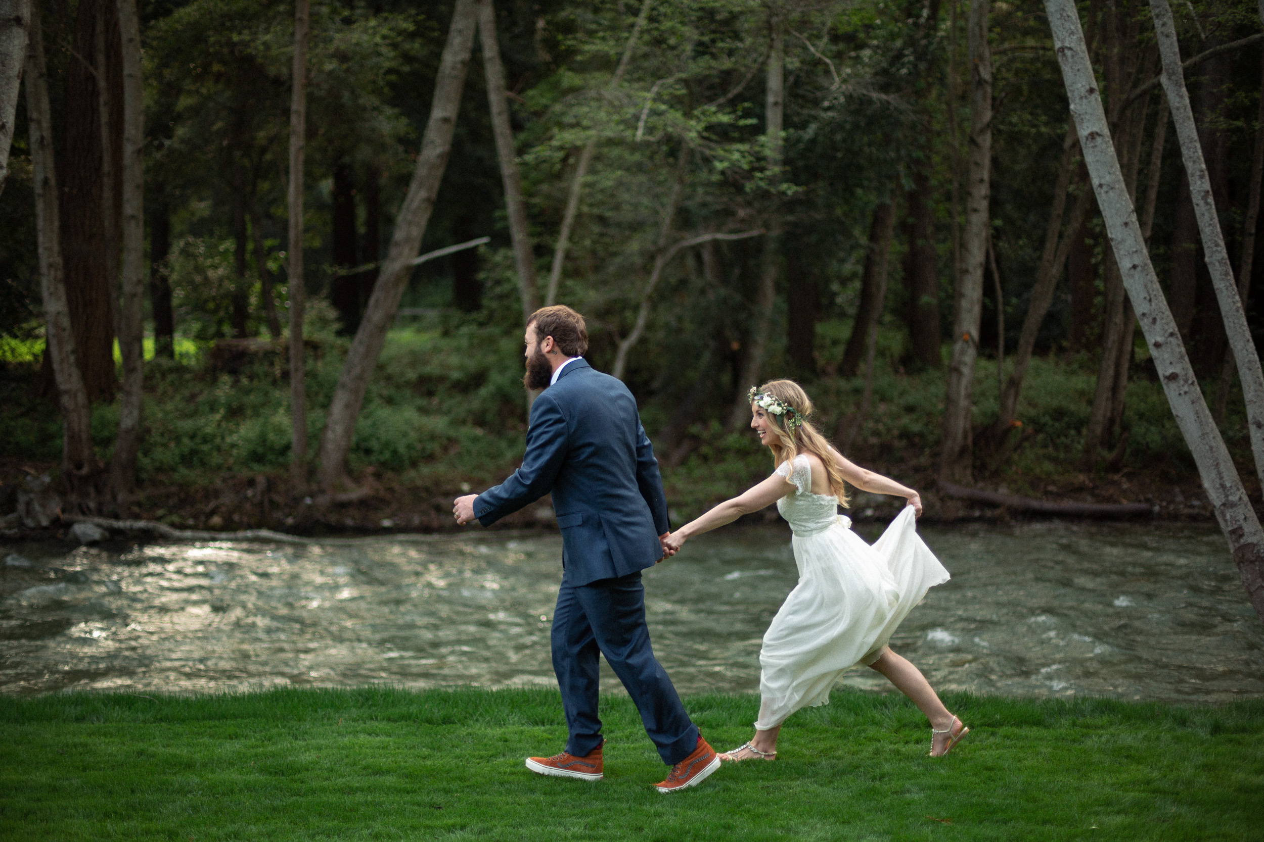 bride and groom running along the big sur river before their wedding - big sur california wedding - laid back wedding in big sur california - true to life colors in wedding photos