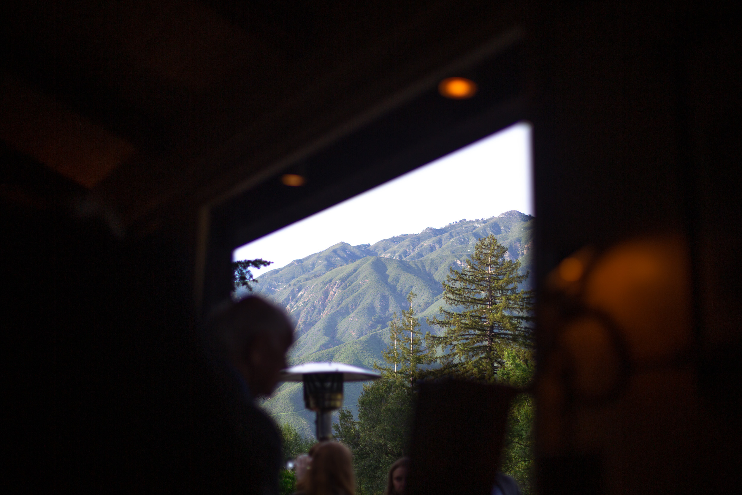 view of coastal mountains and redwood trees from the window of big sur bakery during a springtime california wedding - big sur california wedding - laid back wedding in big sur california - true to life colors